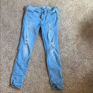 Hollister jeans that have a few rips.